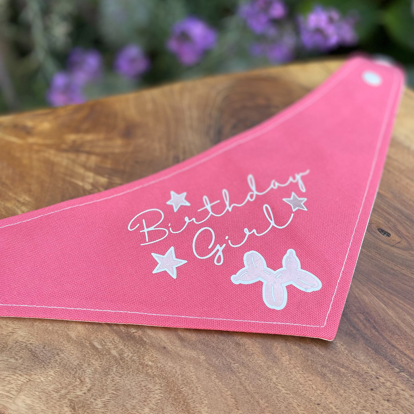 "Birthday Girl" vinyl print dog bandana in bright pink.