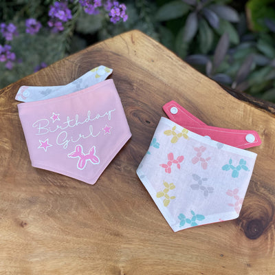 Soft pink "Birthday Girl" vinyl print dog bandana with balloon fabric reverse.