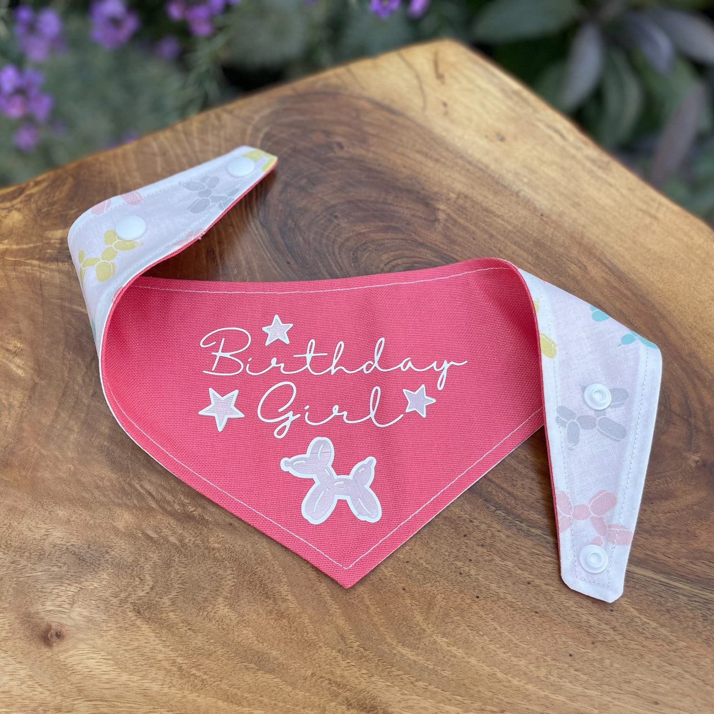 "Birthday Girl" dog bandana with a popper fixing in bright pink.