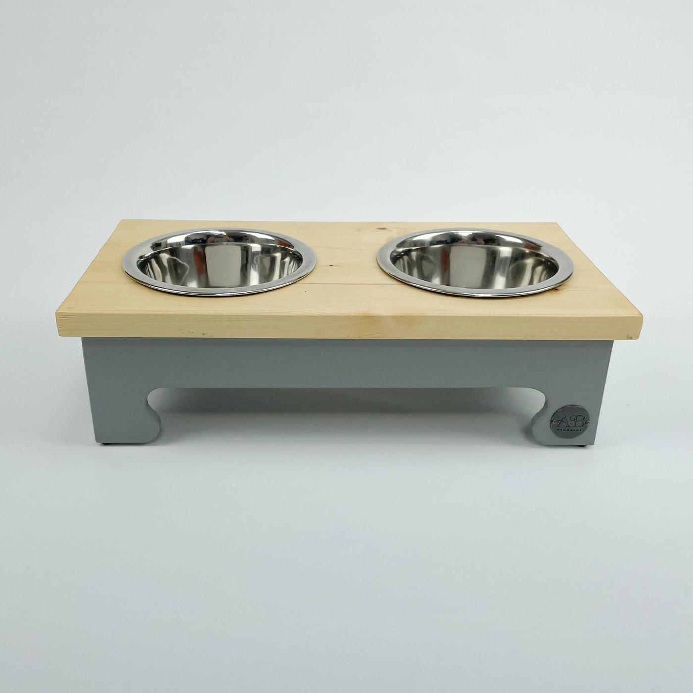 Small pine top raised dog bowl feeding station in grey.