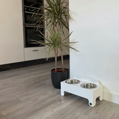 Medium sized,  double-bowl dog feeding station in white.