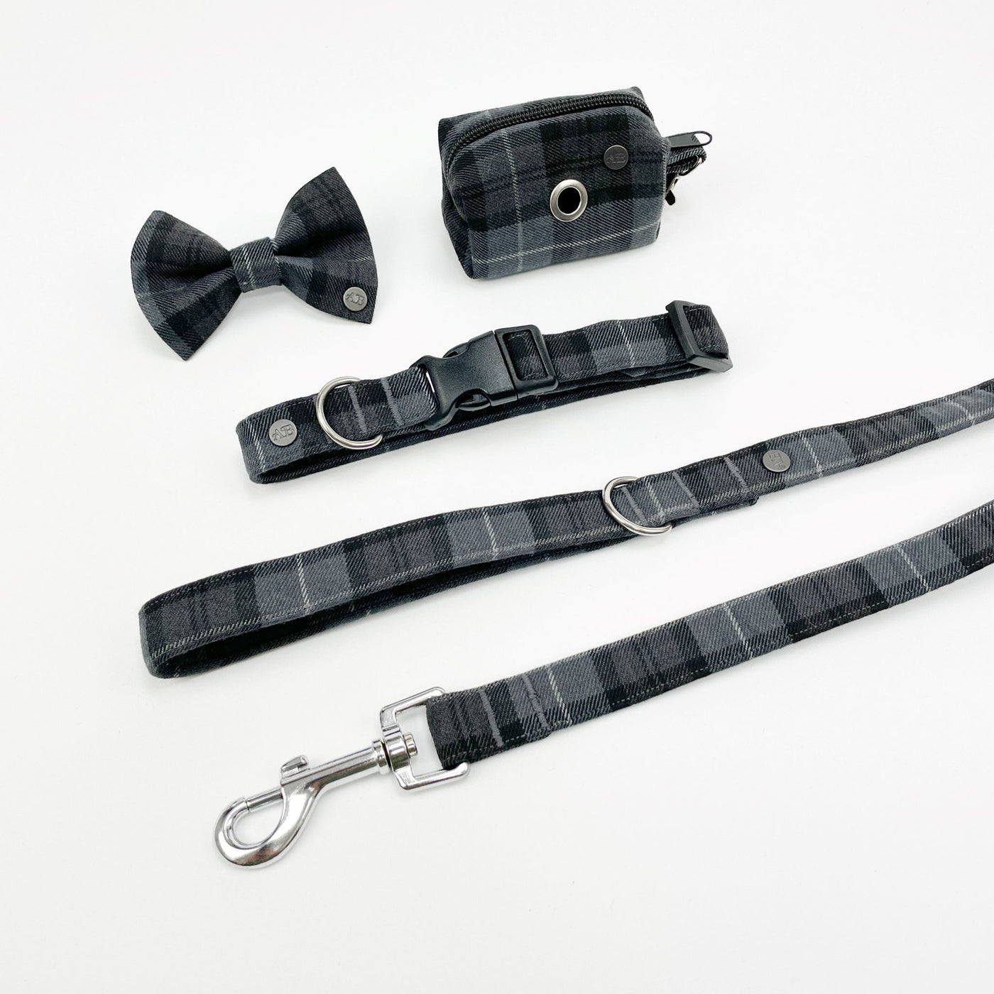 Charcoal grey tartan collection dog-walking accessories.