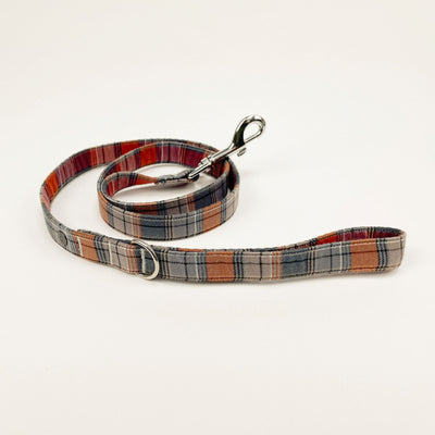 Grey and orange autumn check dog lead with chrome-effect fastenings.