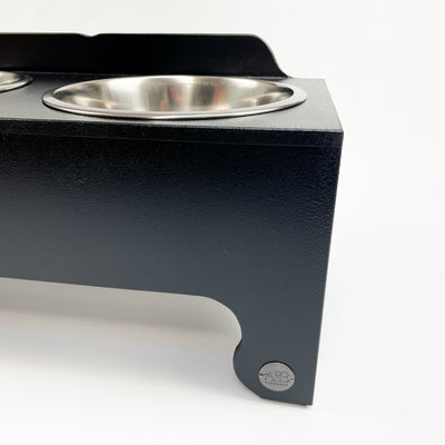 Charcoal black raised dog feeder.