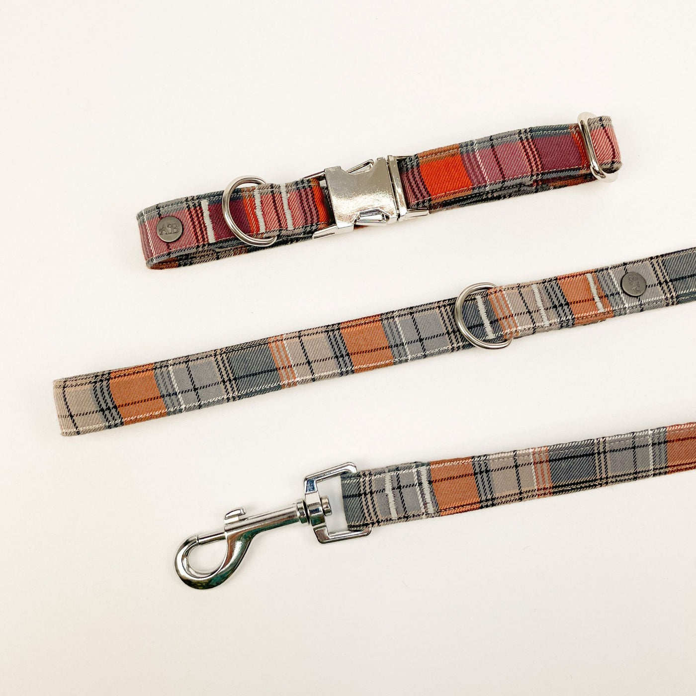 Grey and orange autumn check dog lead with matching check print collar.