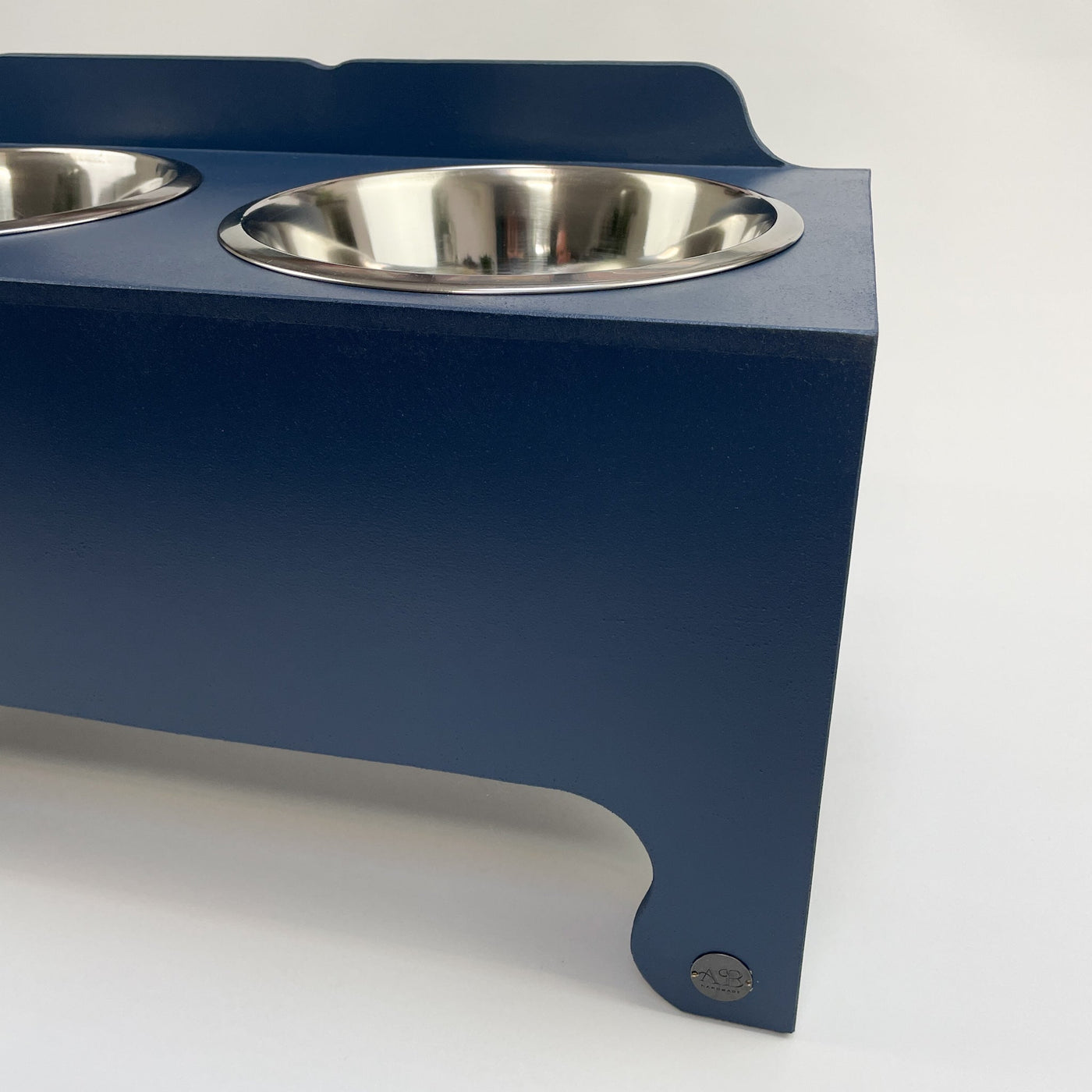 Navy, raised dog feeder with stainless steel food dishes