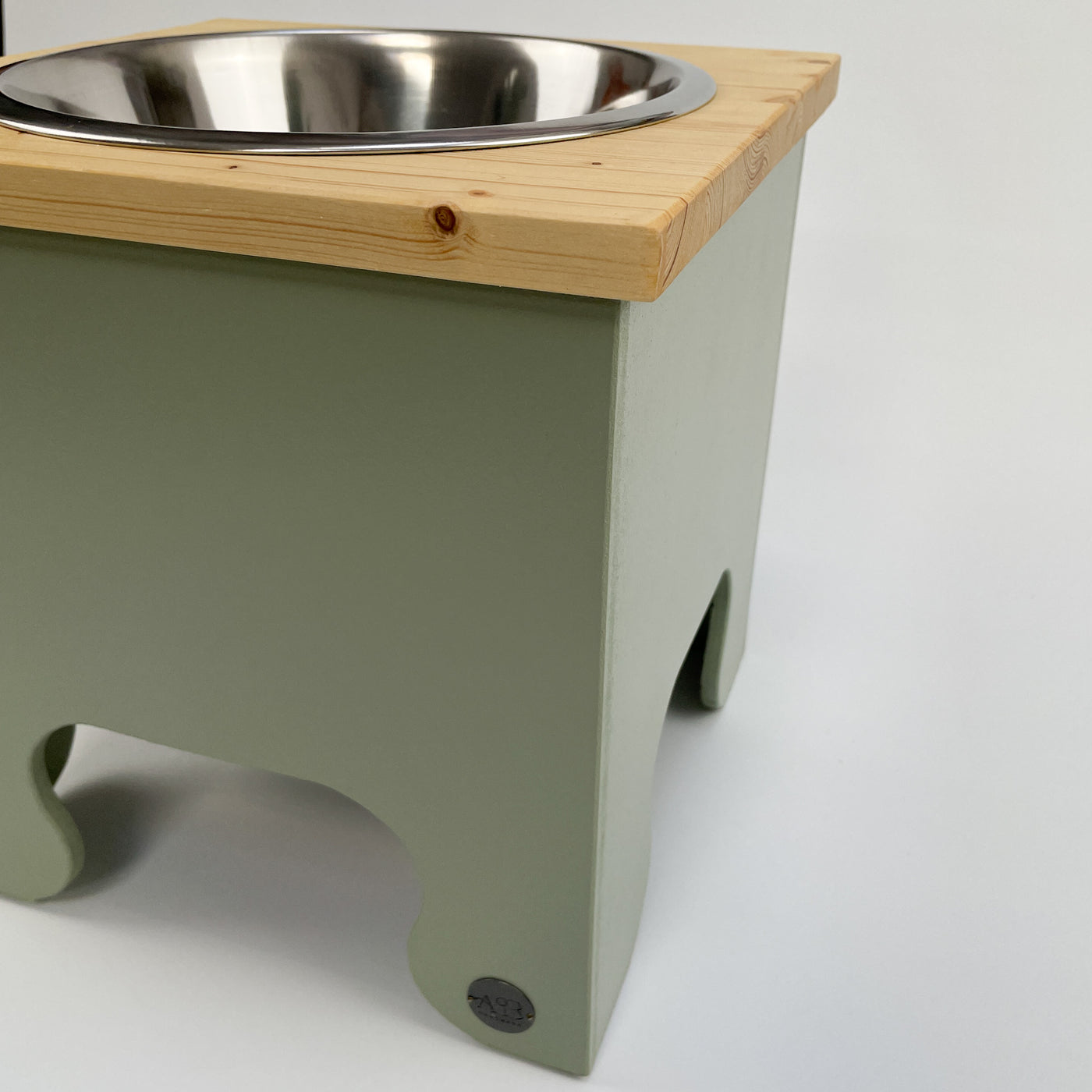Dog Bowl Feeding Stand in soft green, natural pine top.