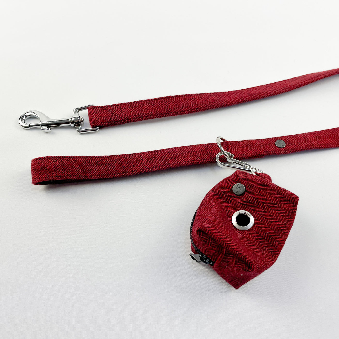 Cranberry Herringbone poop bag holder attached to lead