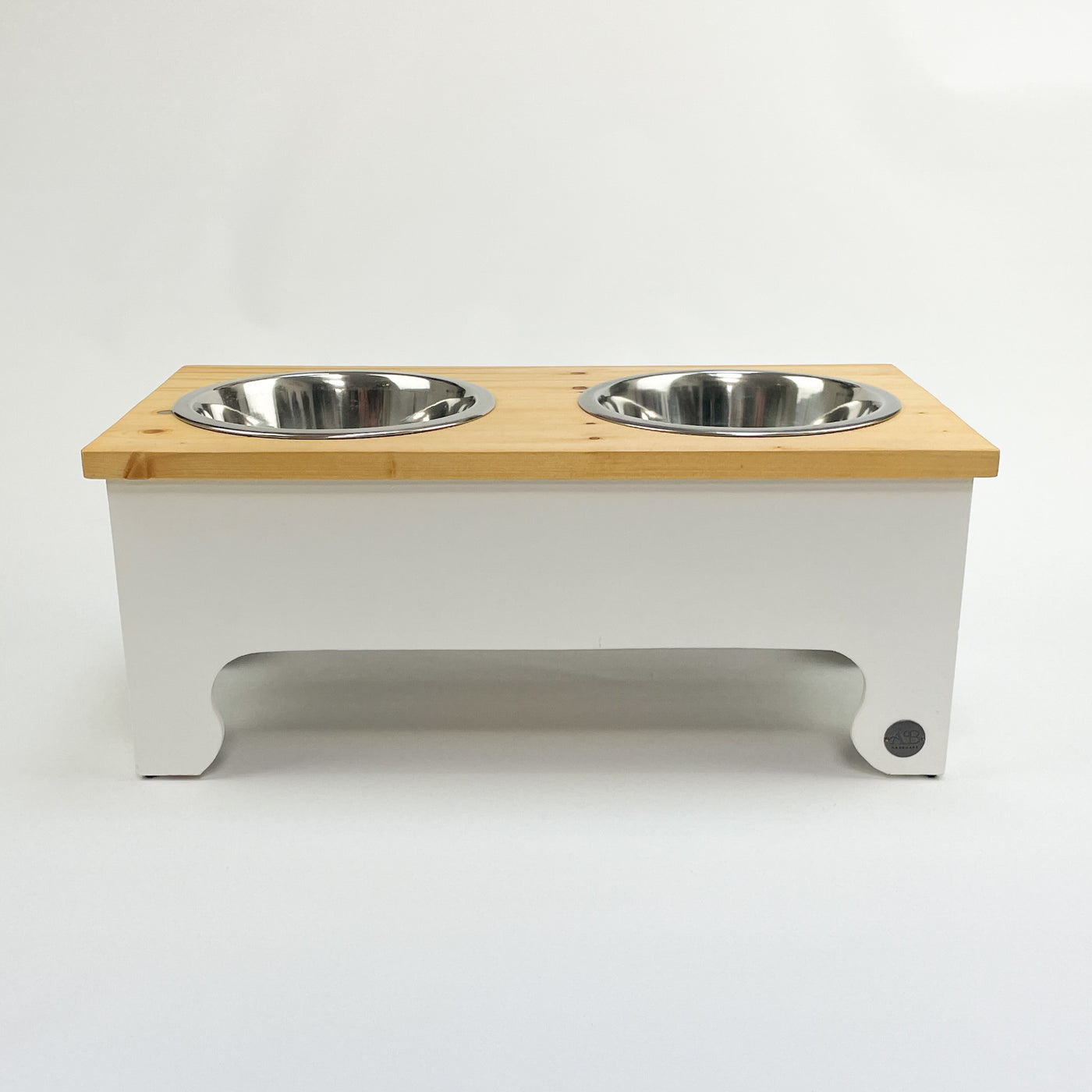 White double-bowl raised feeder for dogs , natural pine top.