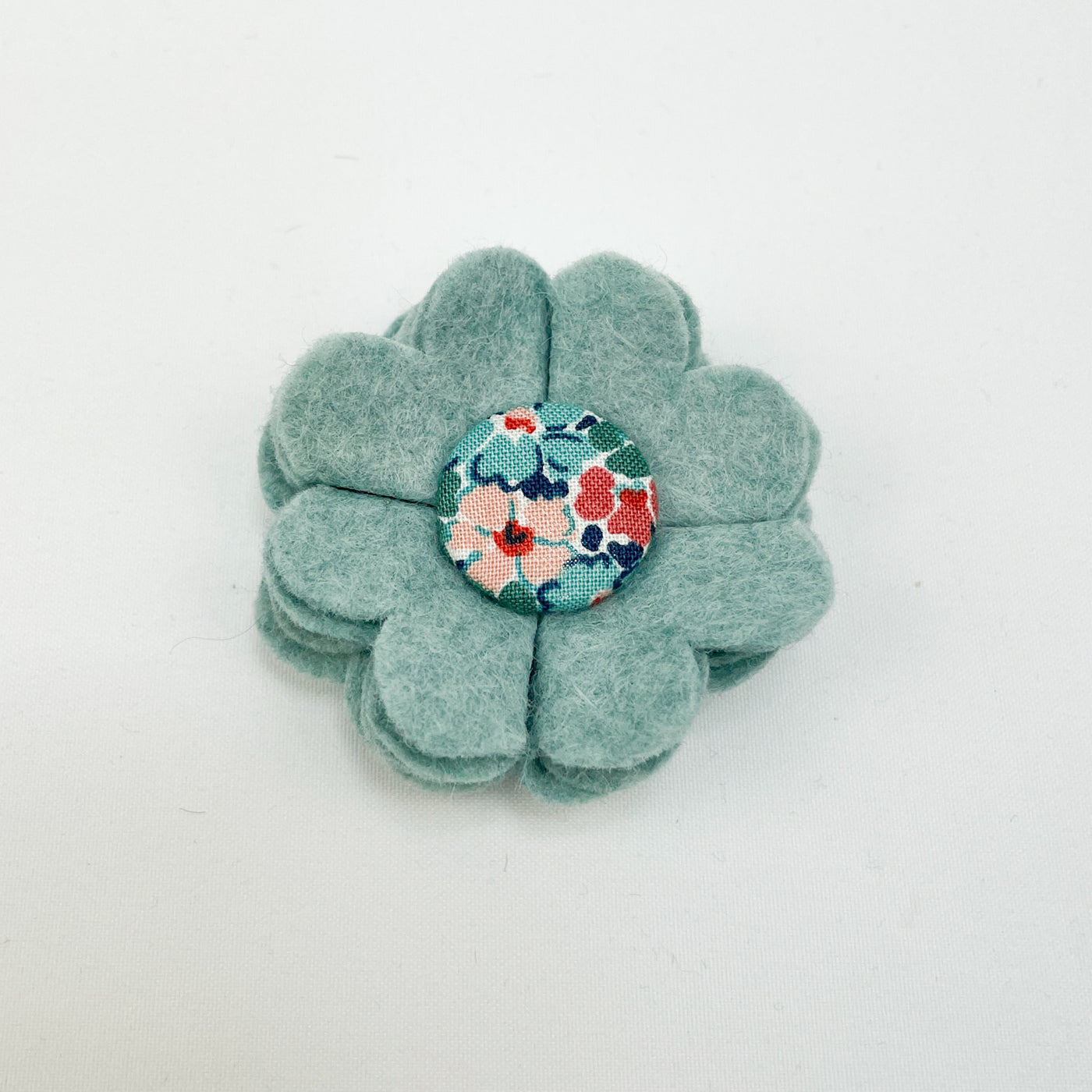 Dog collar flower accessory in soft teal felt with a Liberty fabric button