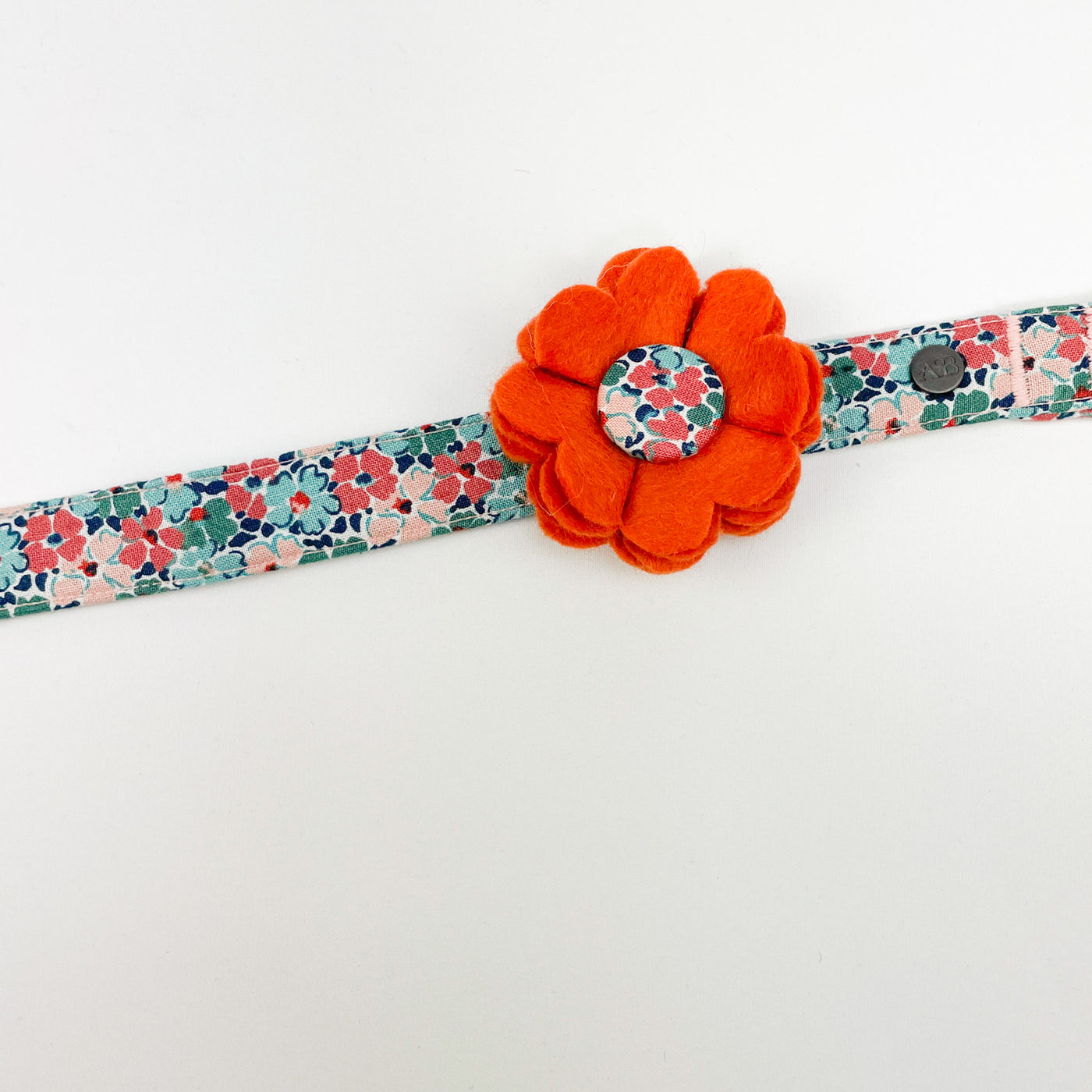 Dog Collar Flower Accessory in orange felt with a Liberty Fabric Button shown on Liberty collar.