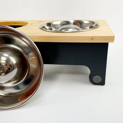 Raised dog feeder with stainless steel slow-feeding bowls.