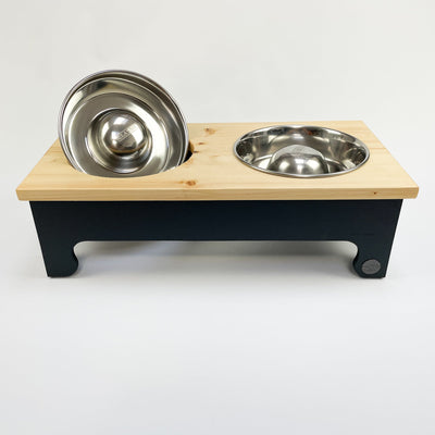 Slow-feed stainless steel bowls in a pine top double feeder, charcoal black.
