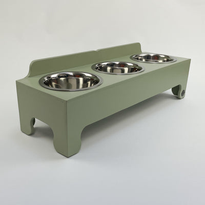 Soft green, medium-sized  raised triple-bowl dog feeding stand with stainless steel dishes.