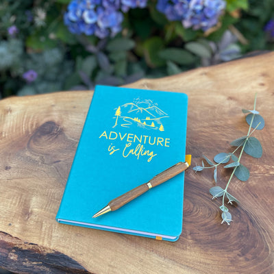 "Adventure is Calling," vegan leather notebook in blue.