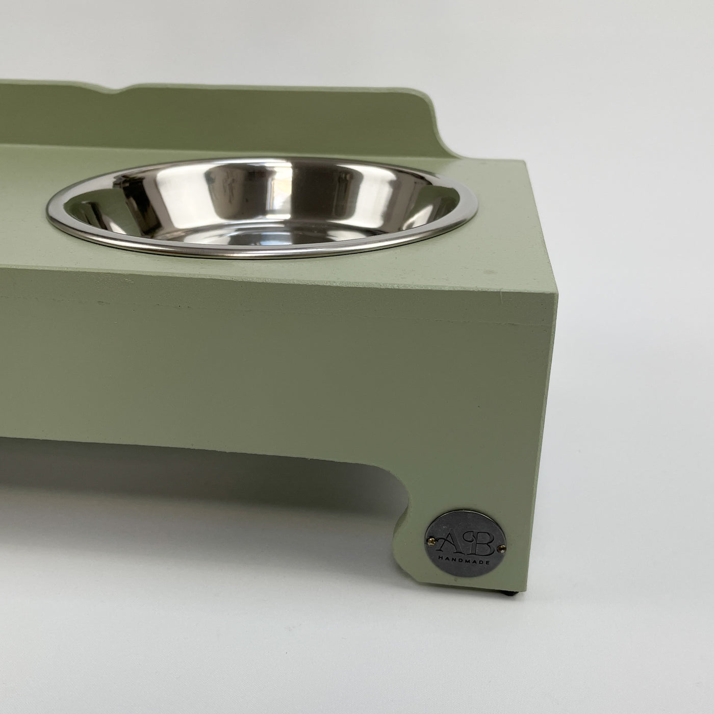 Soft green raised bowl feeding stand with Albie's sea of quality.  
