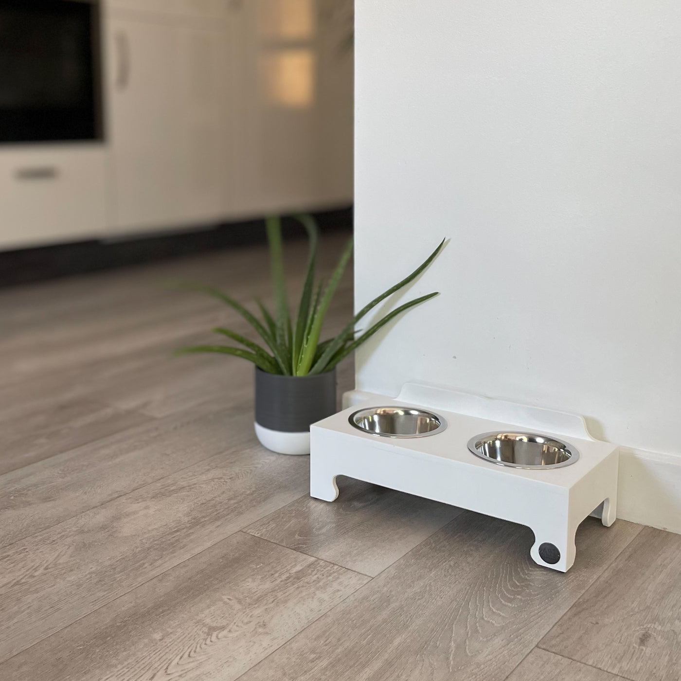 A white double-bowl raised dog feeder in size small