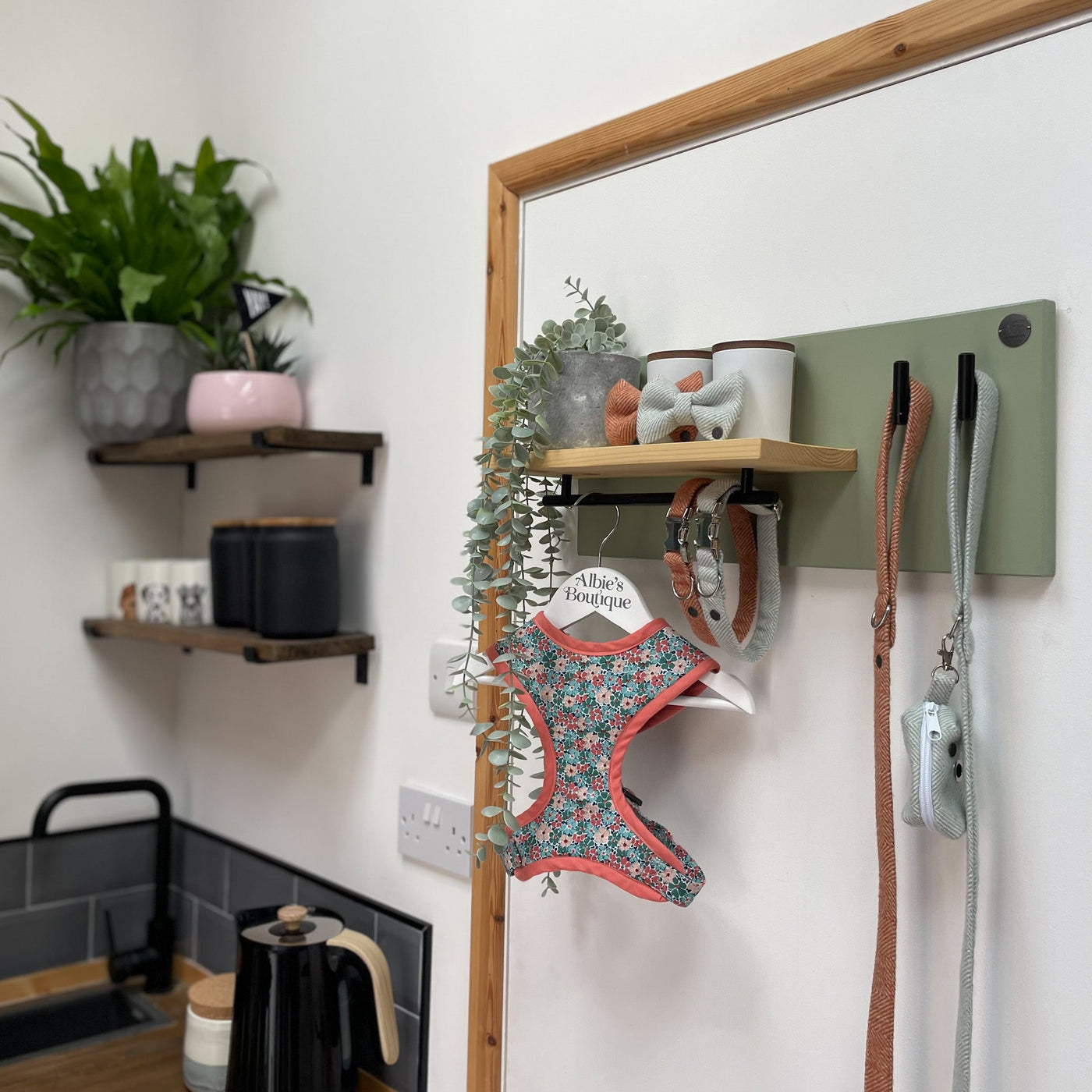 Soft green lead station holds a collection of herringbone print dog walking accessories and Liberty floral print harness.