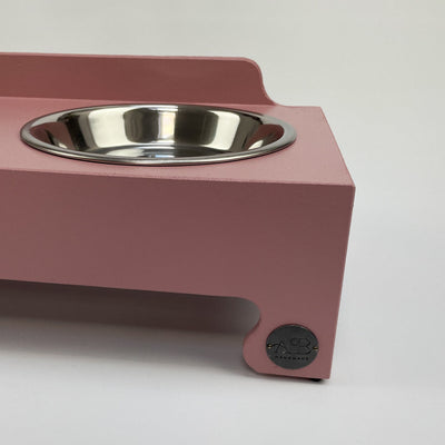 Raised bowl feeding stand in blush pink with Albie's seal of quality