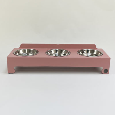 Soft pink raised feeding bowl stand with stainless steel dishes. 
