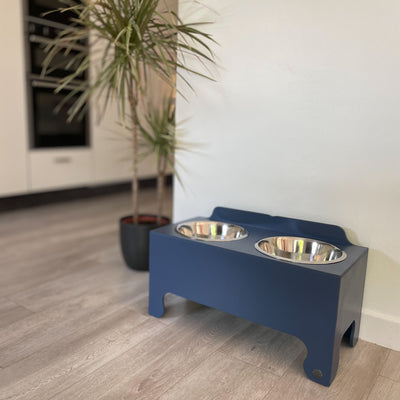 Navy extra large raised dog feeding stand with two stainless steel dishes.